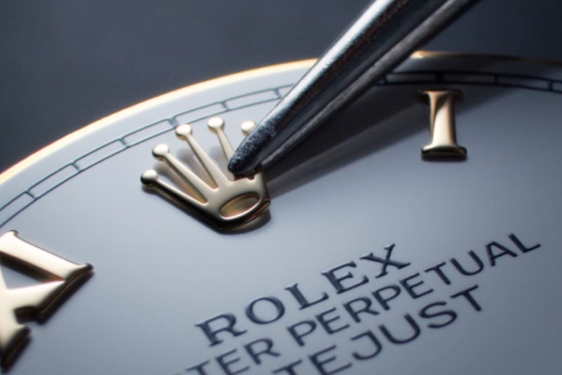 Rolex watchmaking - placing crown on watch face