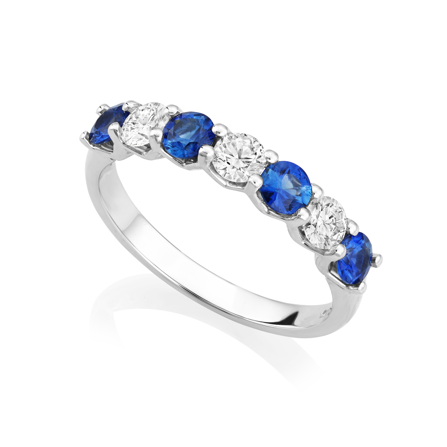 A platinum seven stone sapphire and diamond half eternity ring, belonging to H. L. Brown's Volante collection.