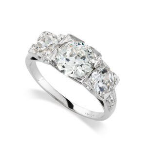 A platinum old brilliant cut diamond three stone ring.