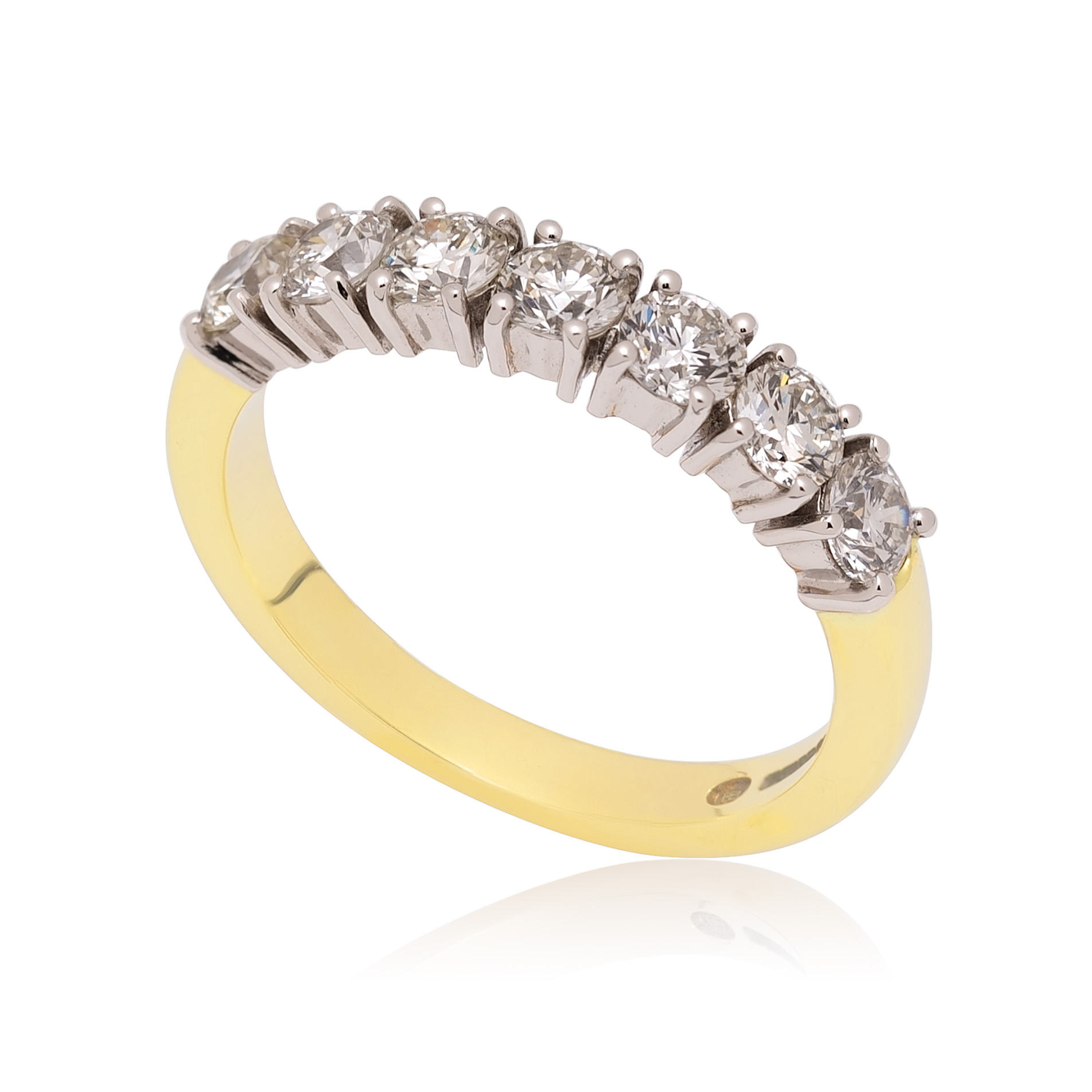 001-1879.jpg An 18ct yellow gold and platinum round brilliant cut diamond seven stone half eternity ring, with a claw setting.