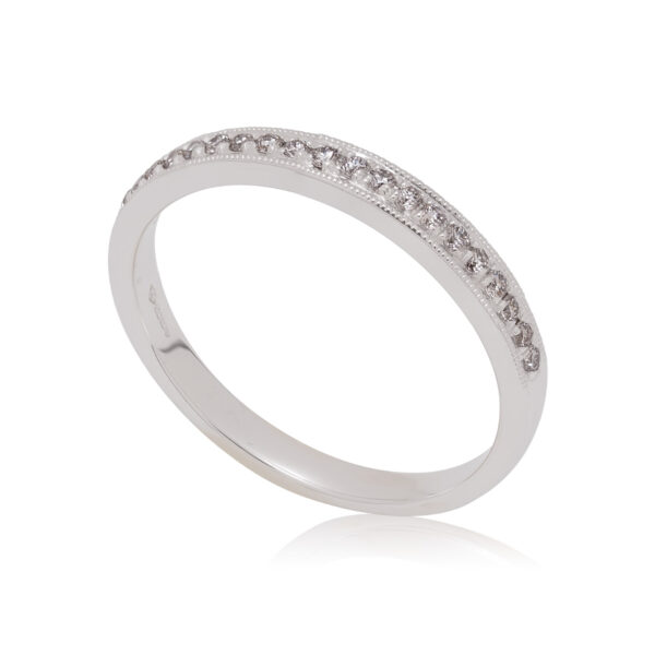A platinum round brilliant cut diamond millegrain set half eternity ring.