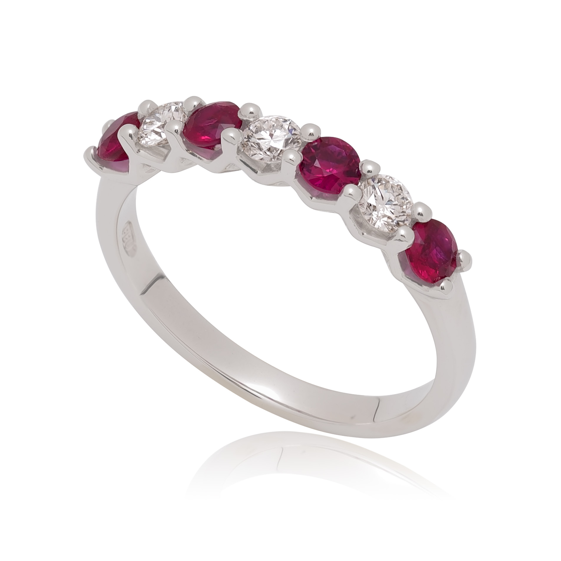 A platinum ruby and round brilliant cut diamond half eternity ring in a setting, containing seven stones belonging to the H. L. Brown Volante collection.
