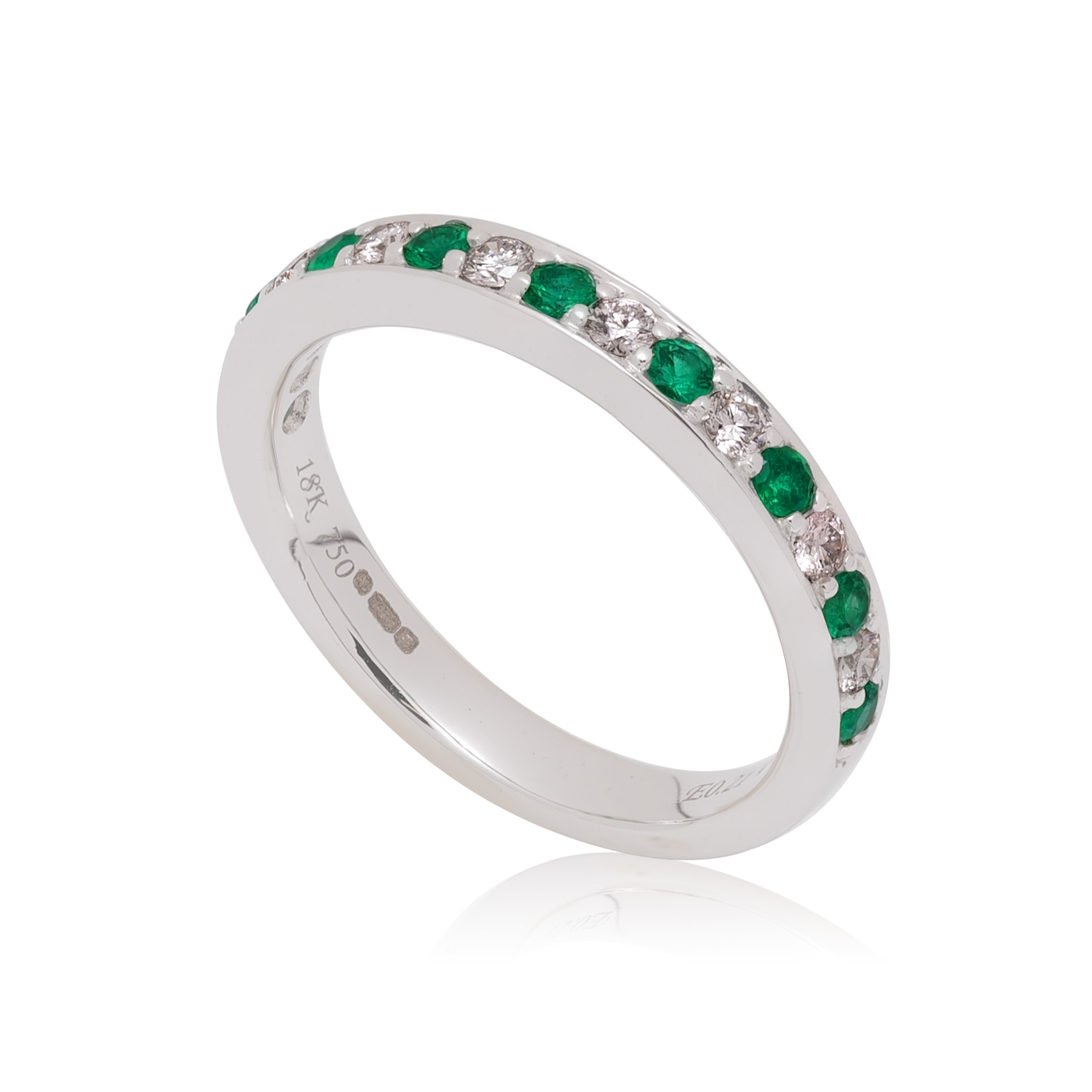 0713460.jpg An 18ct white gold emerald and diamond seventeen stone half eternity ring.