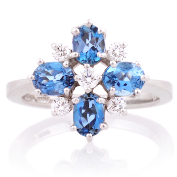 An 18ct white gold nine stone aquamarine and diamond set fancy cluster ring.