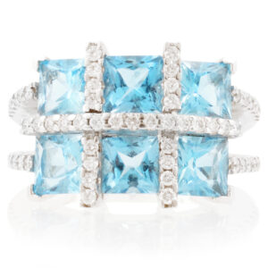 An 18ct white gold blue topaz six stone fancy cluster ring with diamonds set to the shoulders.