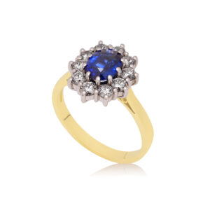 An 18ct yellow and white gold oval shaped sapphire and diamond cluster ring.