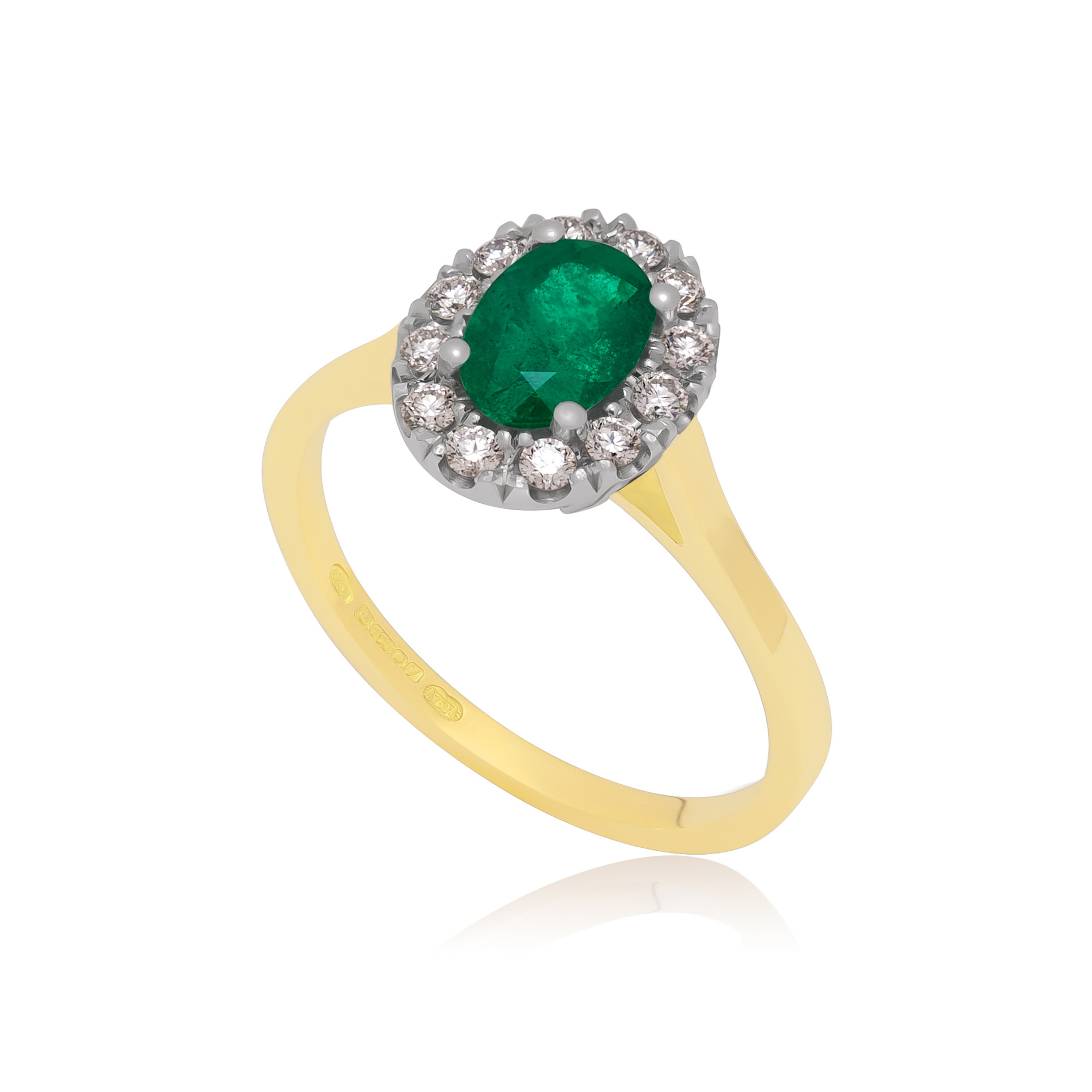 10-16-01104518 An 18ct gold and platinum oval shaped emerald and diamond cluster ring, containing twelve brilliant cut surrounding diamonds.