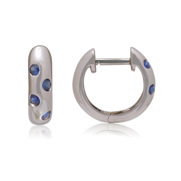 A pair of 18ct white gold hoop style earrings set with four sapphires on each earring, for pierced ears.