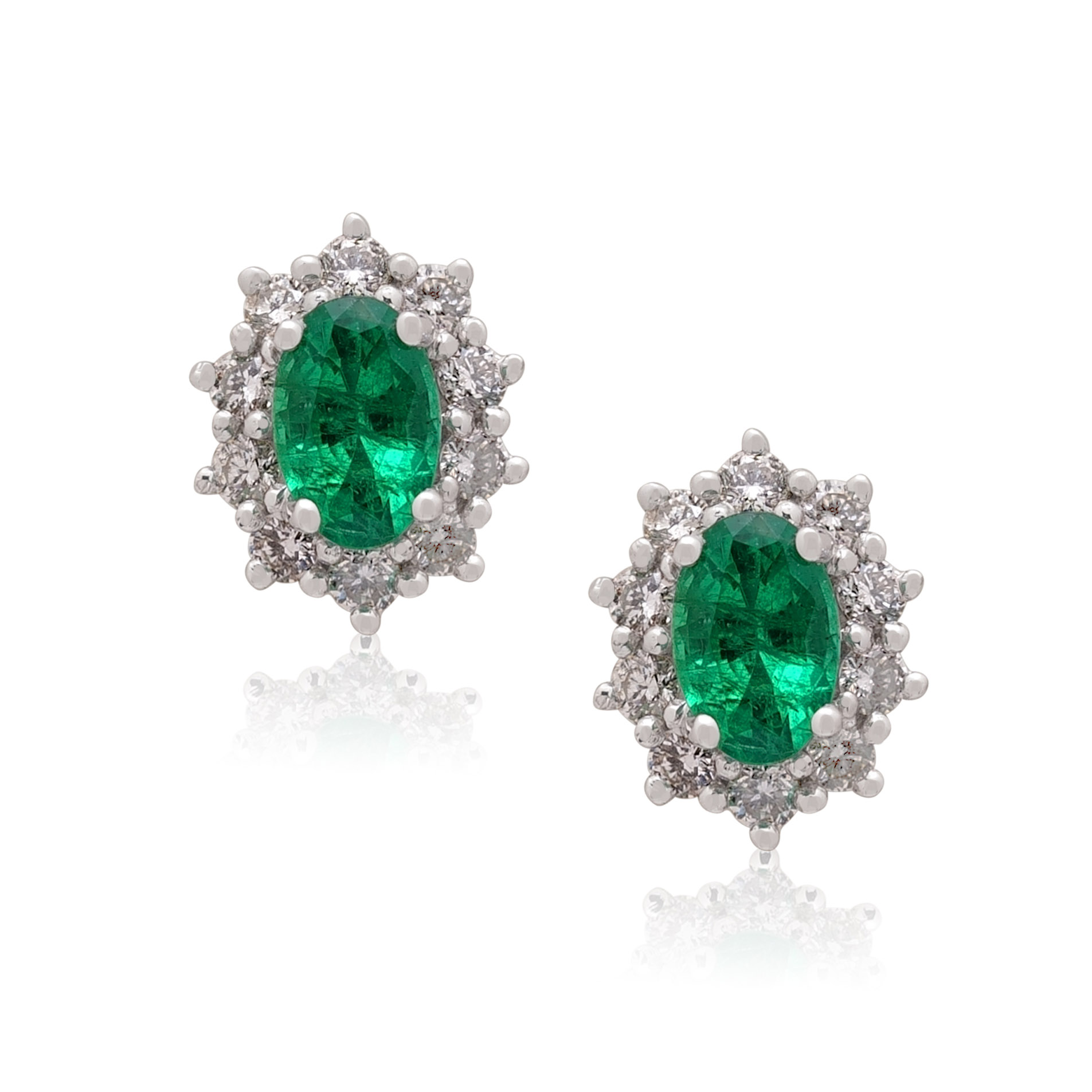 A pair of 18ct white gold oval emerald and diamond set cluster stud earrings, for pierced ears.