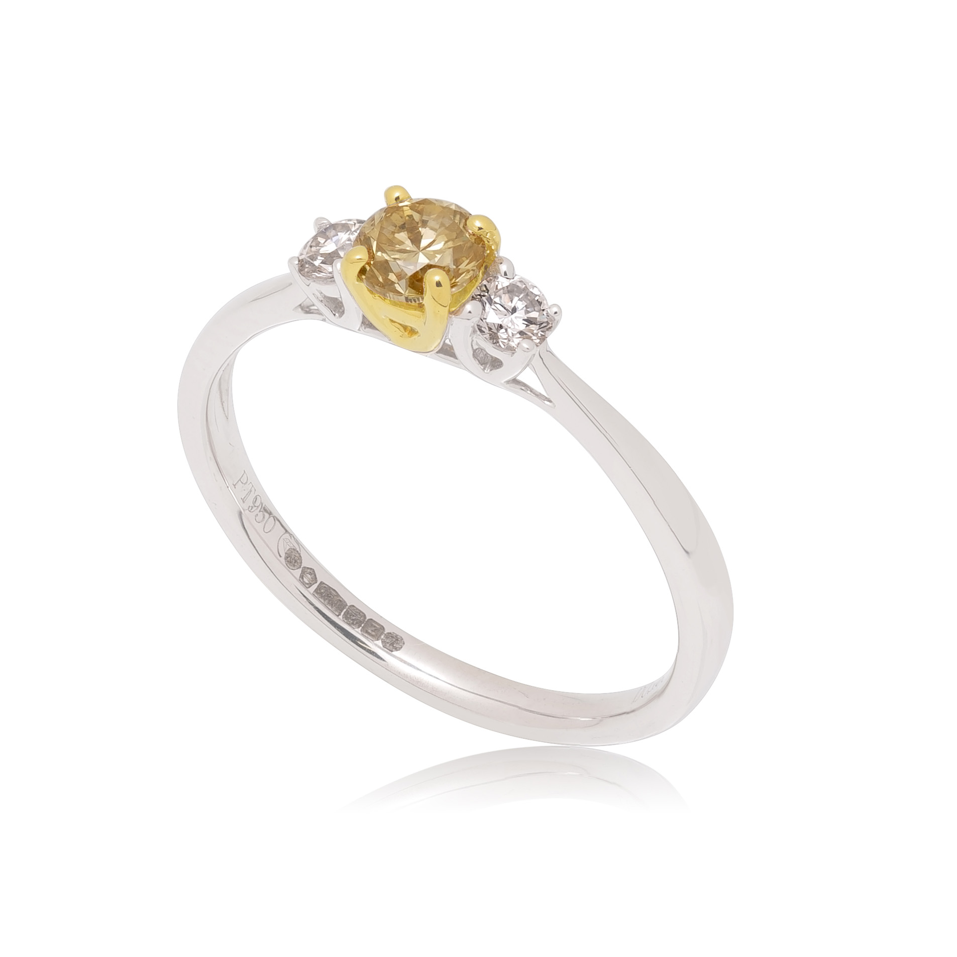 A platinum and 18ct yellow gold round brilliant cut diamond three stone ring, featuring a central yellow fancy diamond.