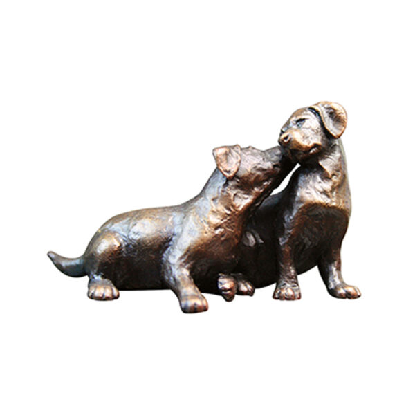 Made from solid foundry bronze, this piece depicts two labrador puppies nuzzling together in a loving, sibling embrace.