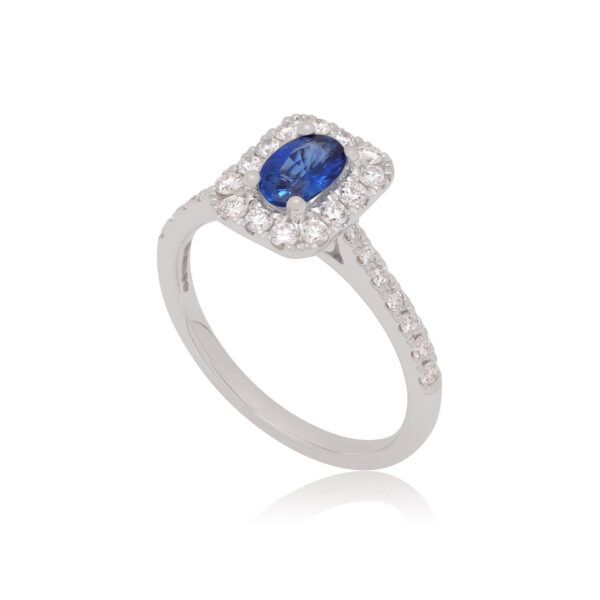An 18ct white gold oval shaped sapphire and diamond set cluster ring with diamond set shoulders.
