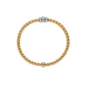 An 18ct yellow gold Flex'It bracelet with three 18ct white gold diamond set rondels belonging to FOPE's EKA collection.
