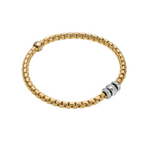 An 18ct yellow gold Flex'It bracelet with three 18ct white gold diamond set rondels belonging to FOPE's EKA collection.