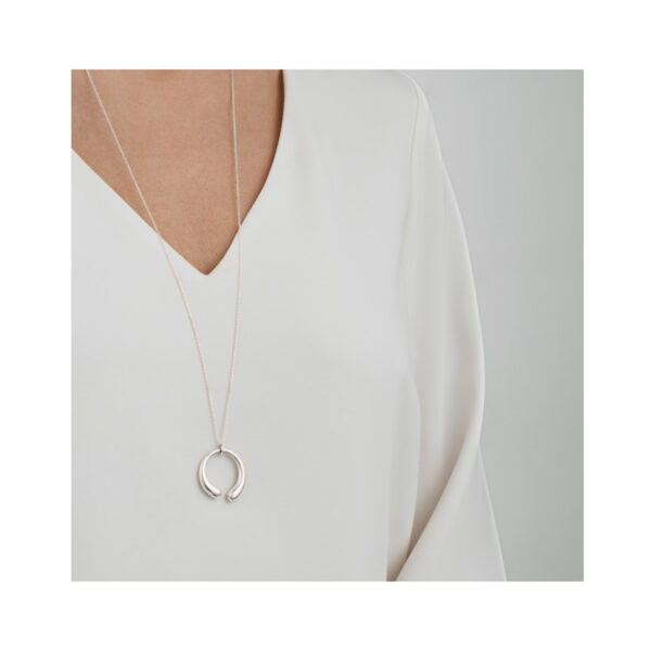 A sterling silver curved pendant and chain belonging to Georg Jensen's Mercy collection.