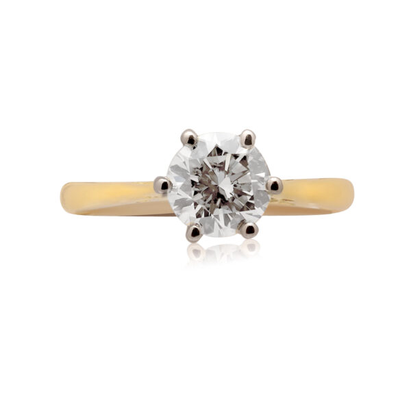 An 18ct yellow and white gold round brilliant cut diamond set solitaire ring with a cornet setting.