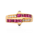 18ct Yellow Gold Ruby & Diamond Ring with Cabochon Sapphires An 18ct yellow gold ring with square cut rubies, round brilliant cut diamonds and cabochon sapphires set to the side.
