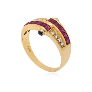An 18ct yellow gold ring with square cut rubies, round brilliant cut diamonds and cabochon sapphires set to the side.