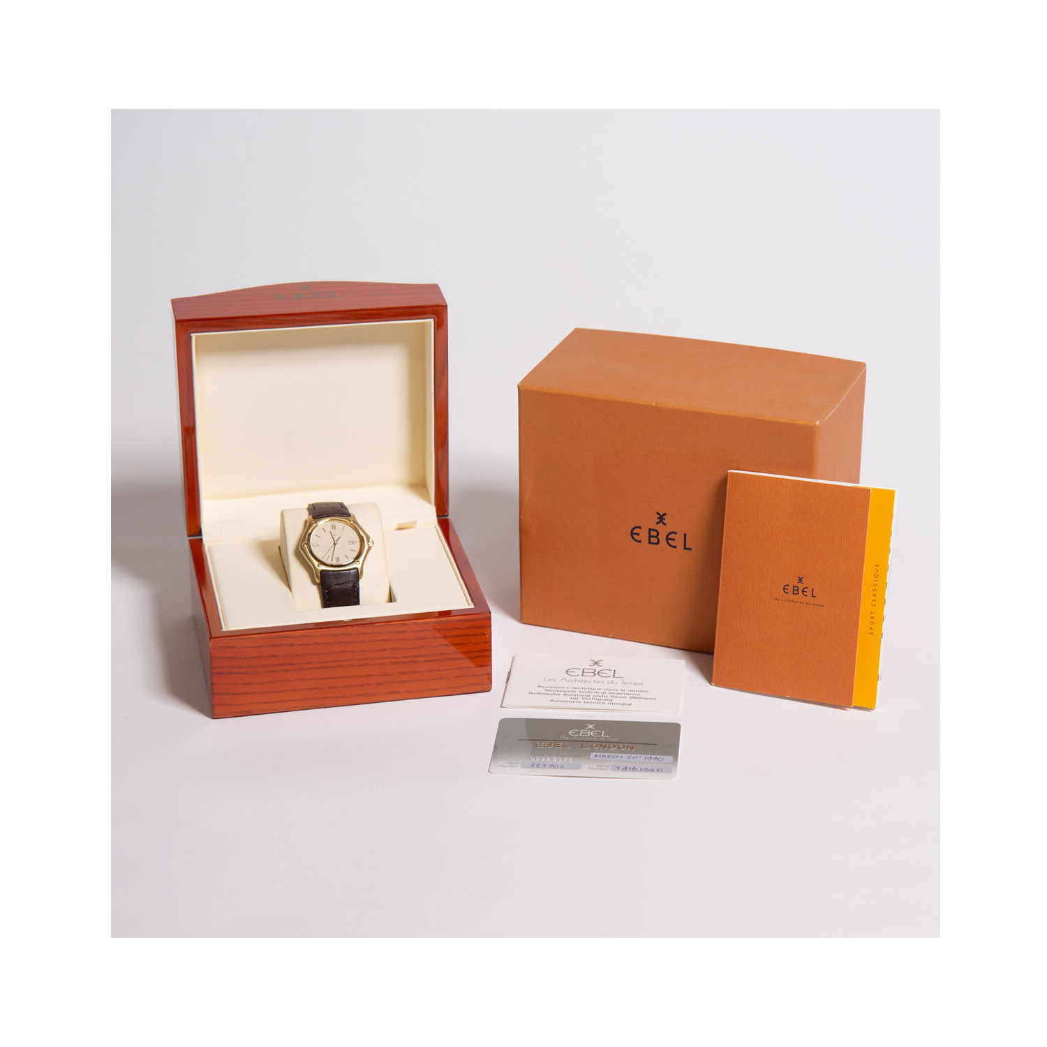 Ebel, 1911 with a 36mm 18ct yellow gold case with a brown crocodile leather strap featuring a date function and a cream dial.