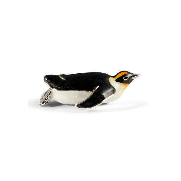 A sterling silver penguin figurine sliding on its stomach from Saturno by Franci Howard.