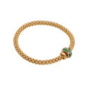 An 18ct yellow gold Flex'It bracelet with an emerald and diamond rondel and a polished diamond set rondel, belonging to FOPE's Solo collection.
