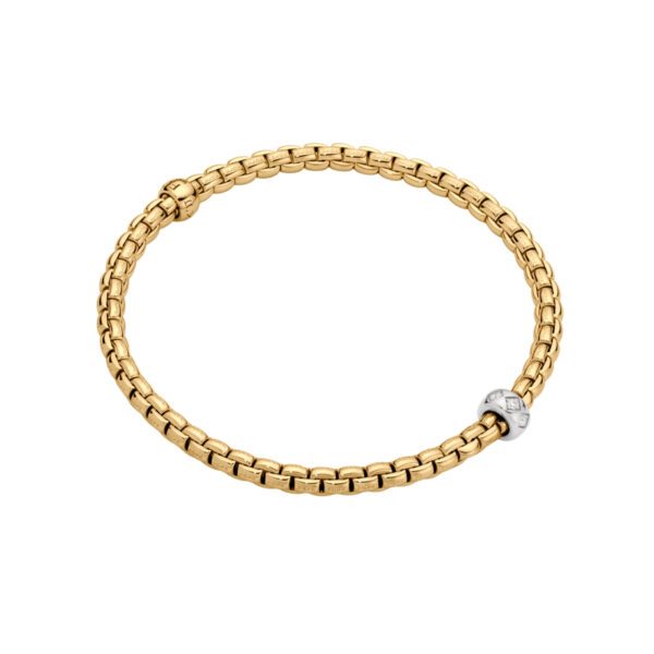 An 18ct yellow gold Flex'It bracelet with a single 18ct white gold diamond set rondel belonging to FOPE's EKA Collection.