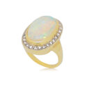 An 18ct yellow gold rubover set opal and round brilliant cut diamond cluster ring, with grain settings to the diamonds.