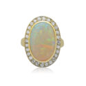 An 18ct yellow gold rubover set opal and round brilliant cut diamond cluster ring, with grain settings to the diamonds.