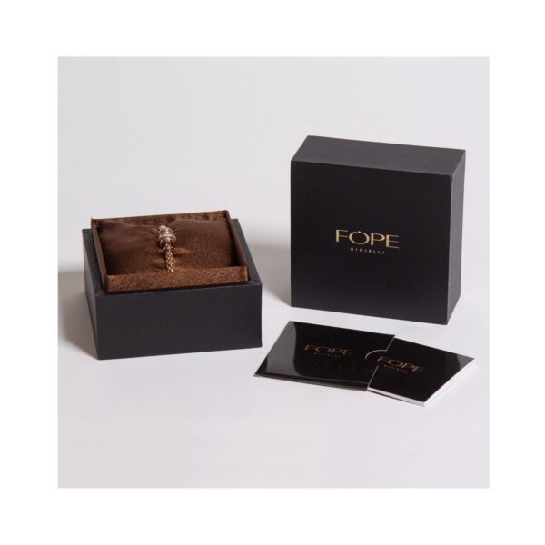 An 18ct rose gold Flex'It bracelet with one diamond set rose gold rondel, two polished rose gold rondels and four polished white gold rondels, belonging to FOPE's Solo collection.