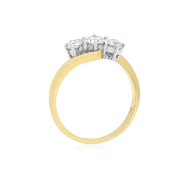 An 18ct yellow and white gold round brilliant cut diamond three stone ring. Hallmarked Birmingham 2011.