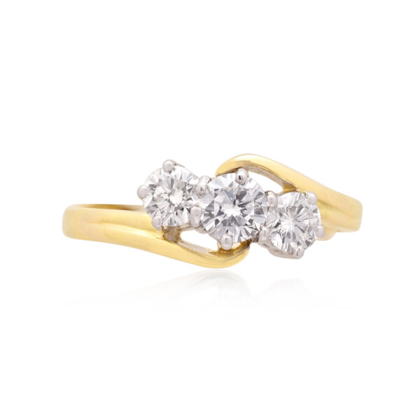An 18ct yellow and white gold round brilliant cut diamond three stone ring. Hallmarked Birmingham 2011.