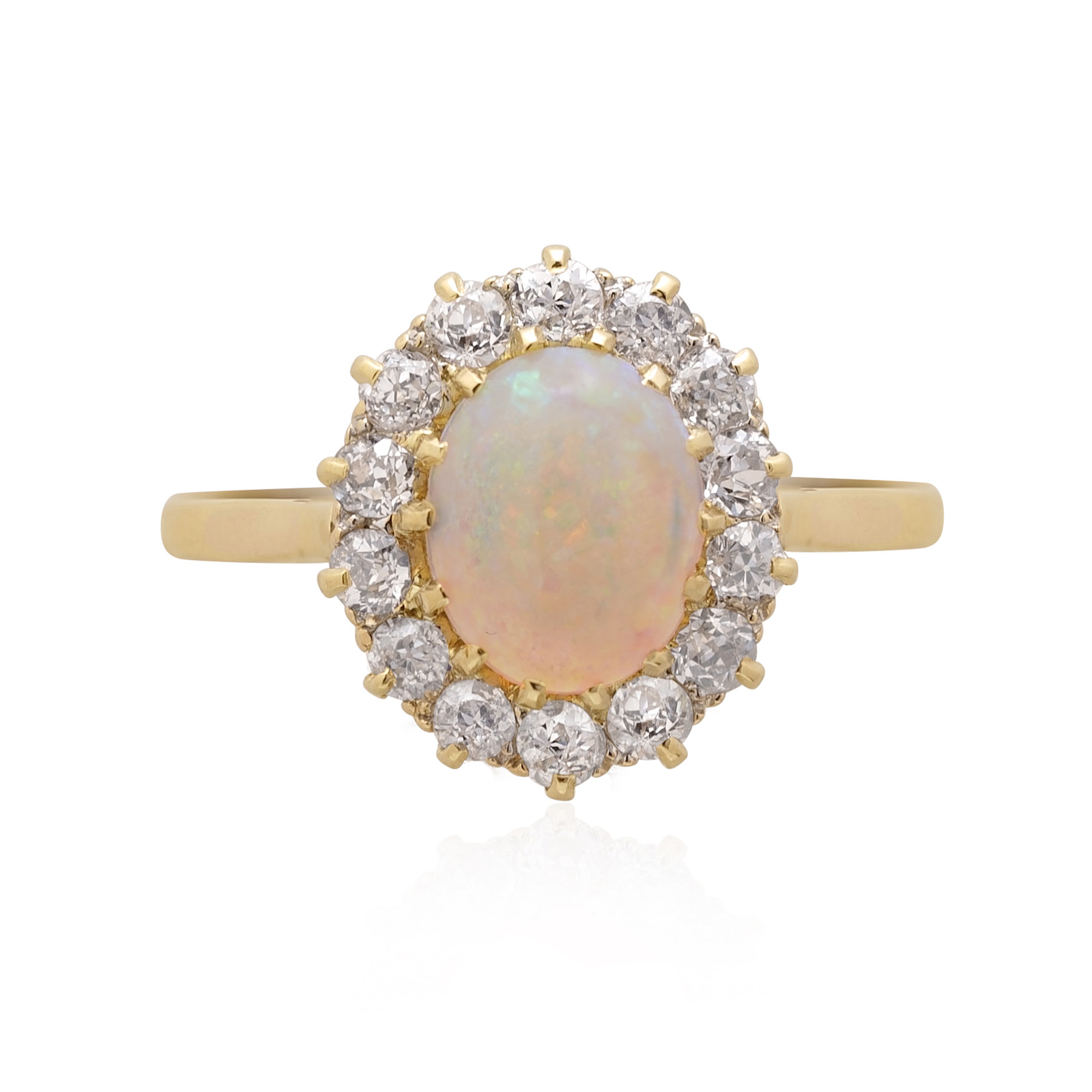 An antique oval shaped opal and old brilliant cut diamond cluster ring.