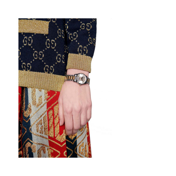 Gucci G-Timeless with a 27mm stainless steel and yellow gold PVD coated case and bracelet strap featuring a silver dial with the cat's head emblem.
