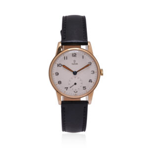 A vintage Tudor watch with a 30mm 9ct yellow gold case with a black leather strap featuring a white dial.