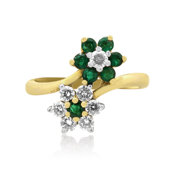 A 14ct yellow and white gold emerald and round brilliant cut diamond flower style double cluster ring.