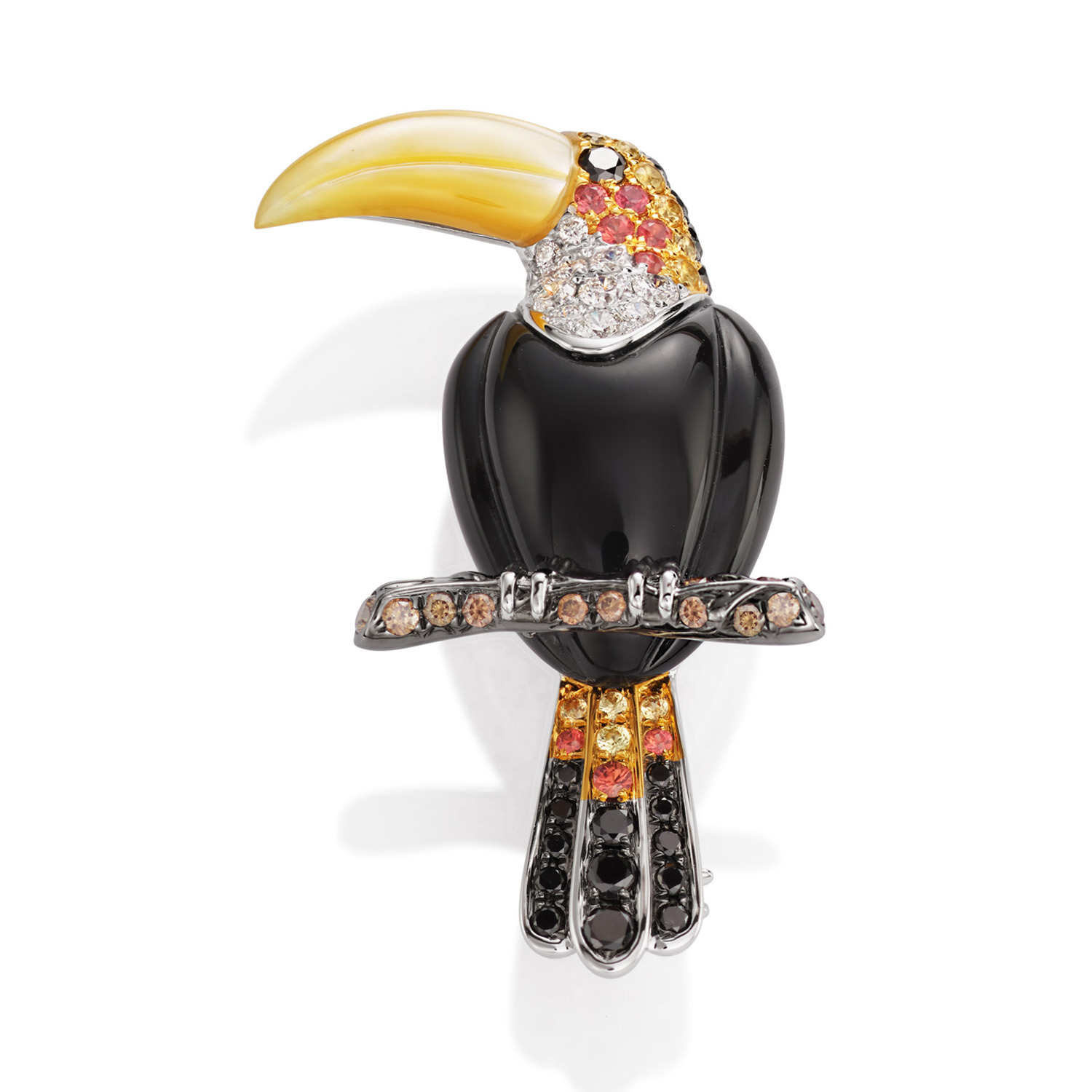 An 18ct white gold Toucan brooch with black onyx body, mother of pearl beak and set with diamonds, black diamonds, cognac diamonds, orange and yellow sapphires.