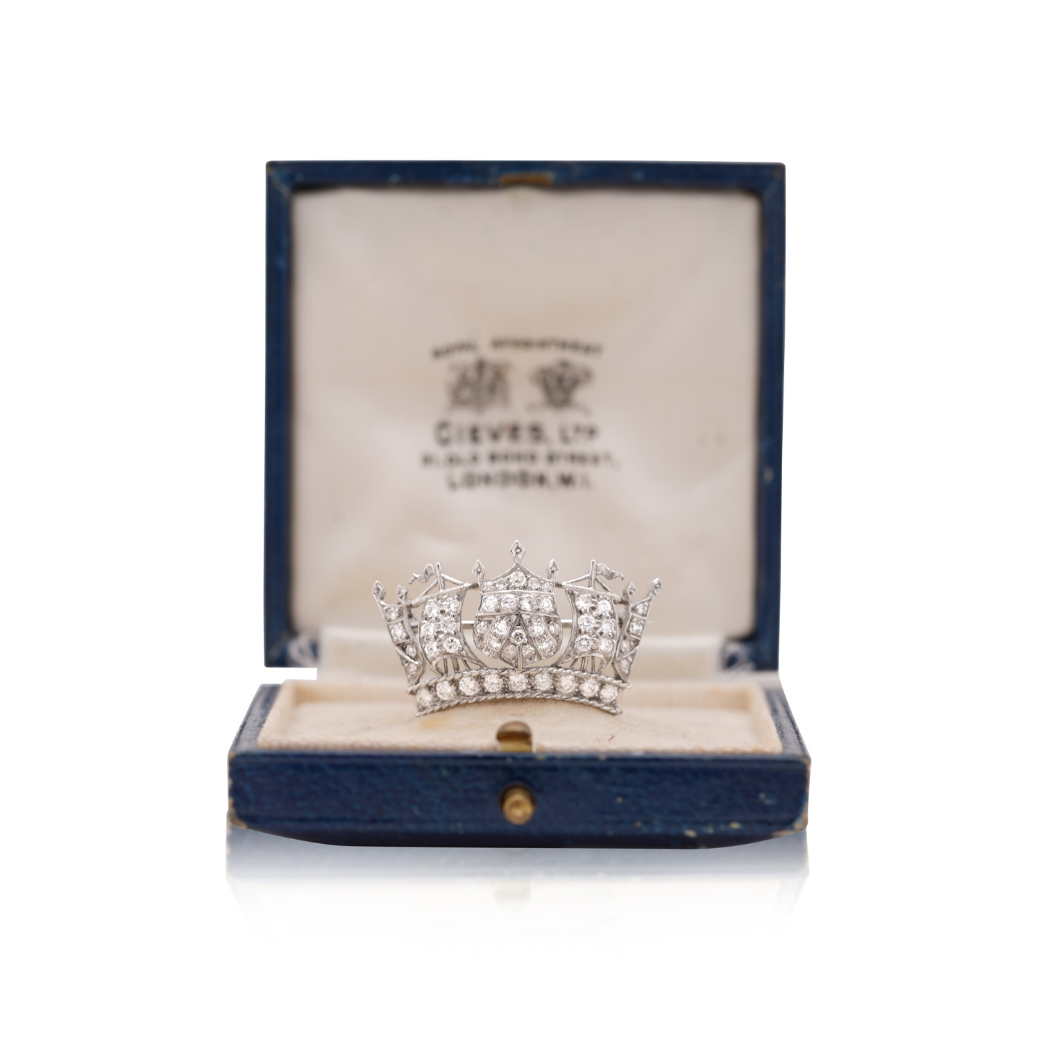 A vintage platinum diamond set crown brooch featuring round brilliant cut and eight cut diamonds.