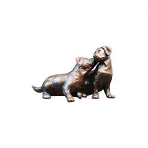 Made from solid foundry bronze, this piece depicts two labrador puppies nuzzling together in a loving, sibling embrace.