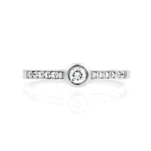 An 18ct white gold round brilliant cut diamond single stone ring with diamond set shoulders.