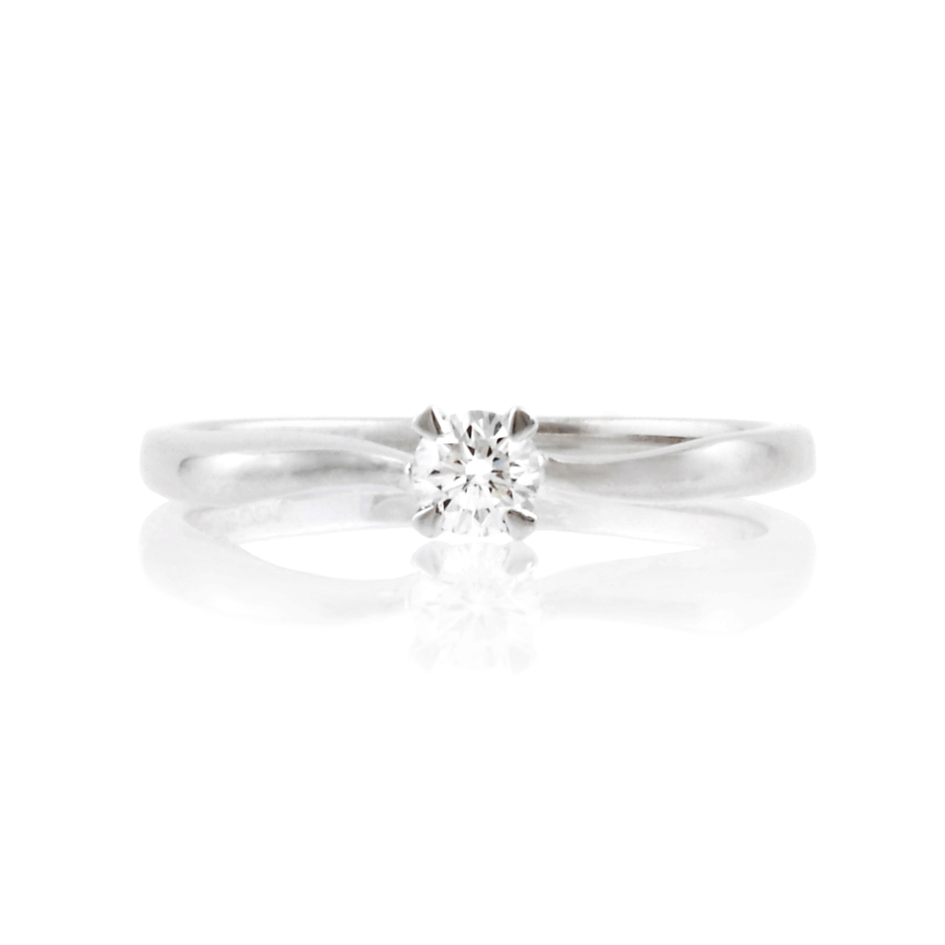 An 18ct white gold, round brilliant cut diamond single stone ring with twist-style shoulders.