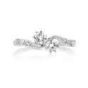 A two stone diamond crossover ring with diamond set shoulders, featuring eight diamonds in total.