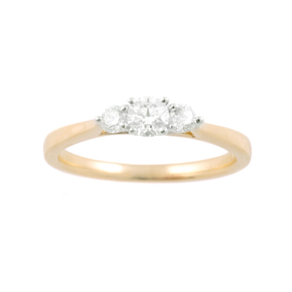 An 18ct yellow and white gold round brilliant cut diamond three stone ring.