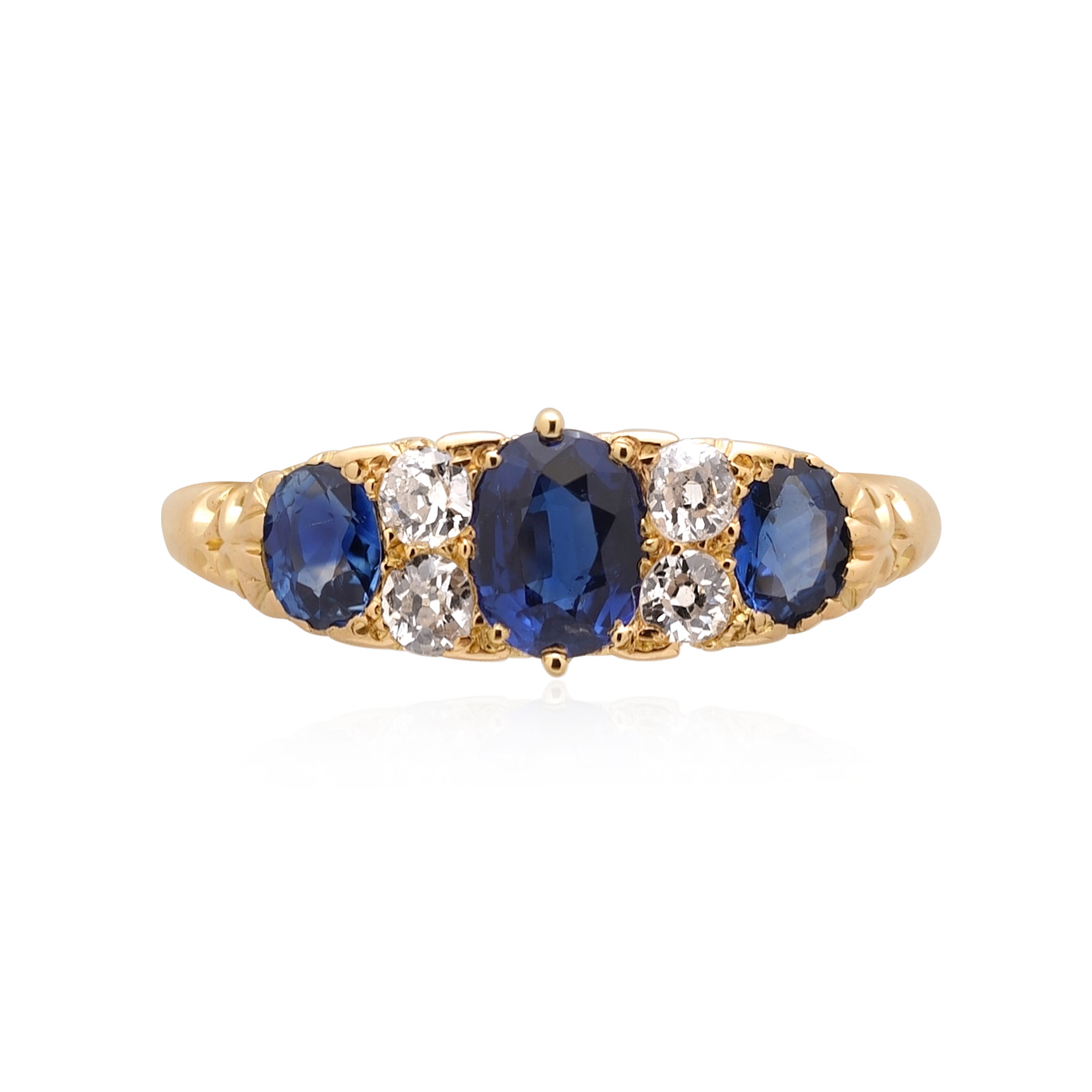 A Victorian 18ct yellow gold sapphire and old swiss cut diamond set seven stone carved head ring.