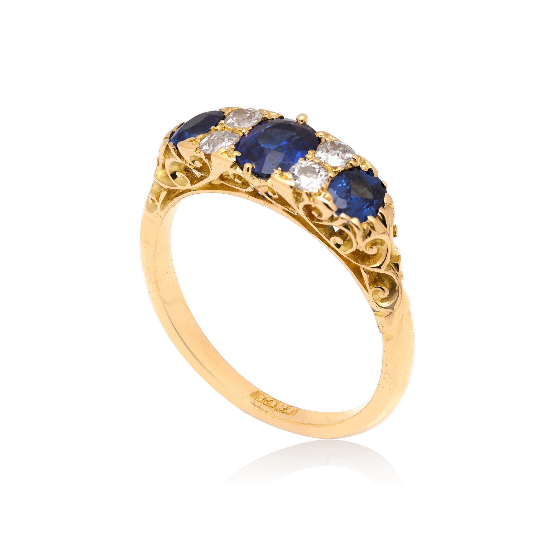 A Victorian 18ct yellow gold sapphire and old swiss cut diamond set seven stone carved head ring.