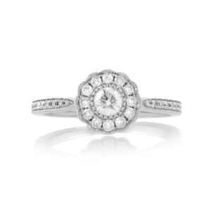 An 18ct white gold, diamond set cluster ring with diamond set shoulders.