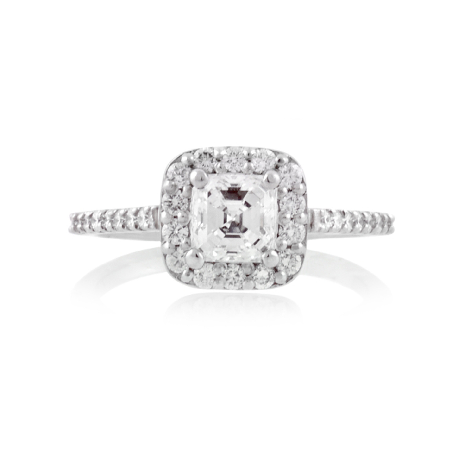 A platinum Asscher cut diamond cluster ring with diamond set shoulders.