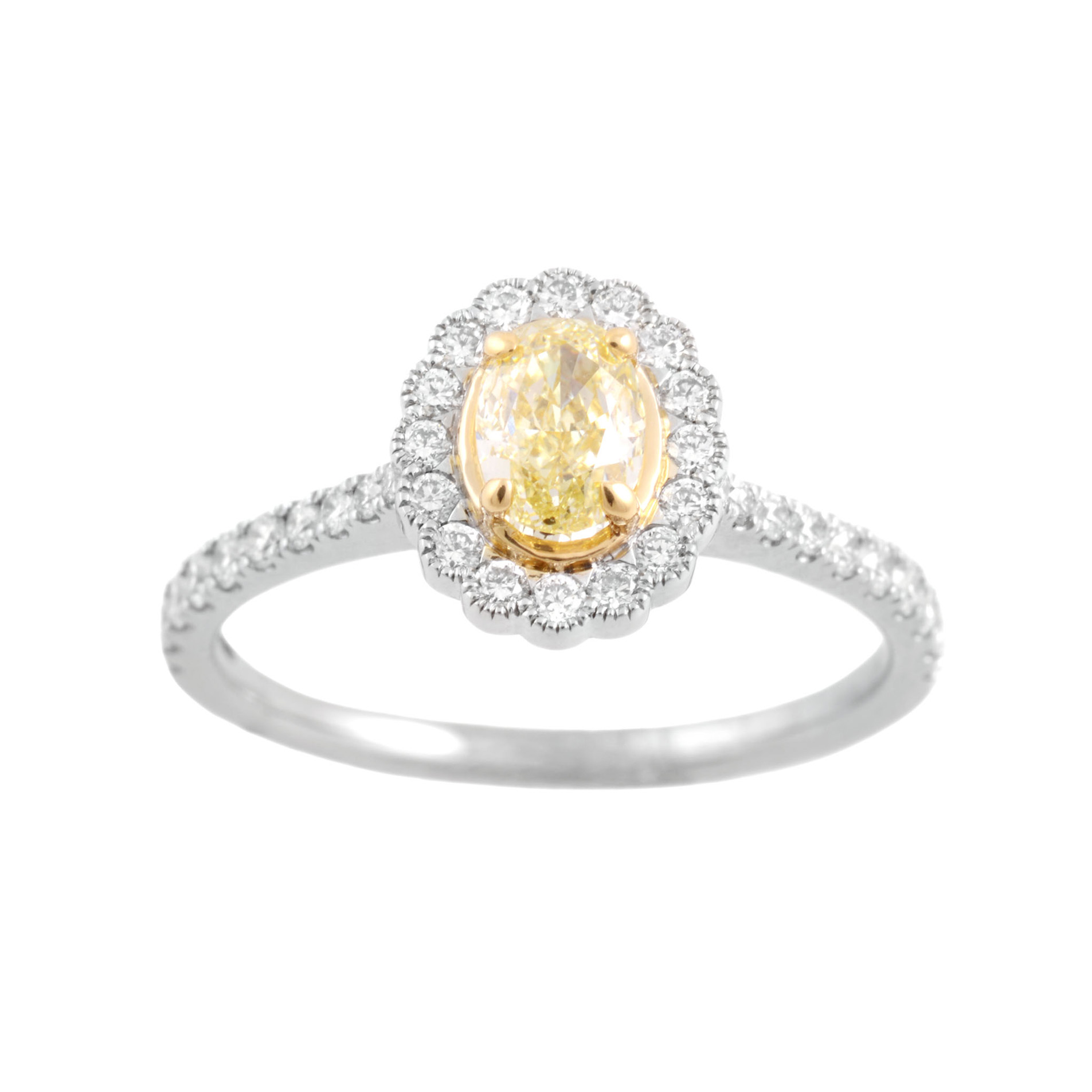 A platinum diamond cluster ring. The central oval fancy yellow diamond is surrounded by round brilliant cut diamonds with further round brilliant cut diamonds to each shoulder.