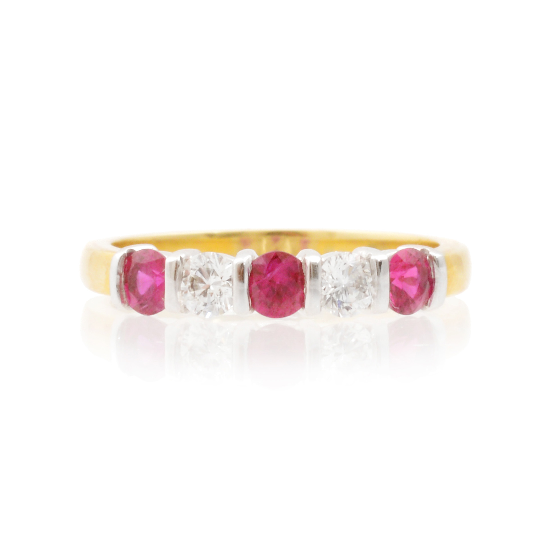 An 18ct gold, ruby and diamond set half eternity ring with five stones.