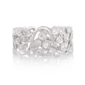 An 18ct white gold, intricate diamond set flower and leaf ring in a band style.