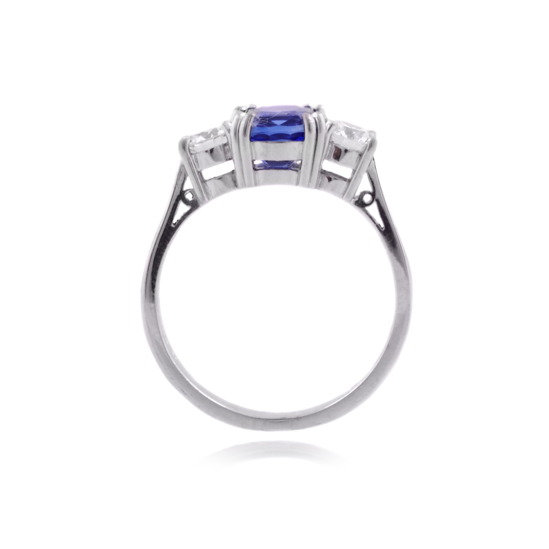 An 18ct white gold, sapphire and brilliant cut diamond set three stone ring.